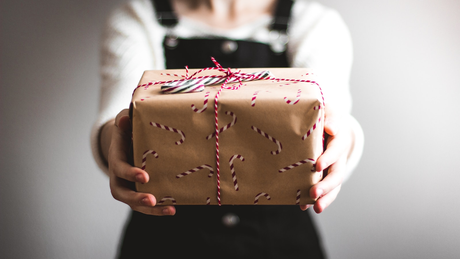 Beautifully wrapped Christmas presents under decorated tree with lights